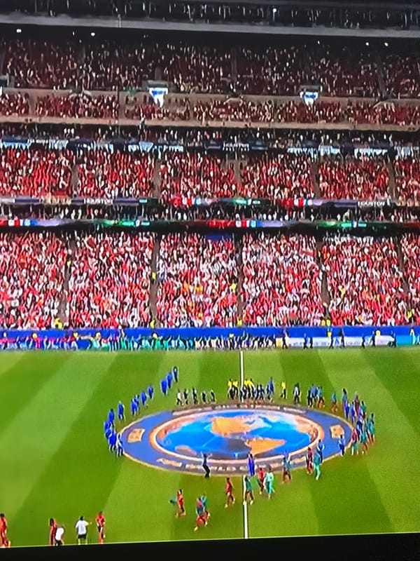 Packed stadium in Yangiiul filled with red-clad crowd