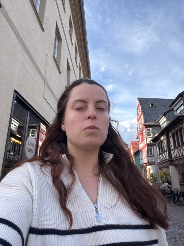 Person enjoys quiet moment on cobblestone street in Meisenheim