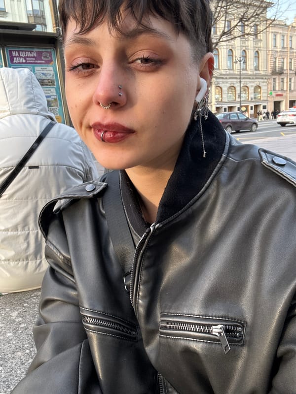 Person with piercings photographs selfie in Saint Petersburg