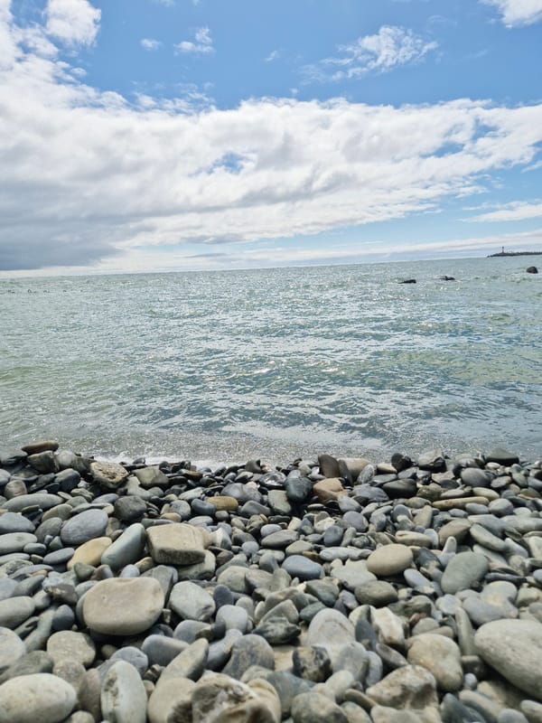 Woman visits Black Sea pebble beach in Sochi