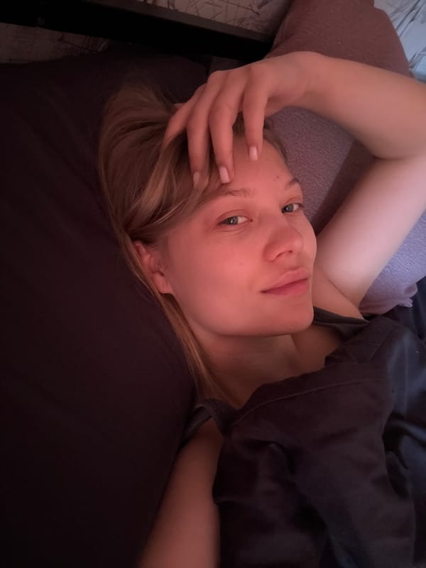 Woman rests in bed early morning in Chaikovsky, Russia