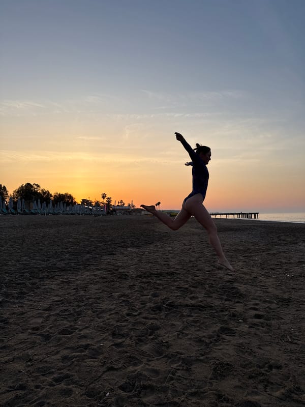 Woman performs dance routine on Turkish beach at sunrise