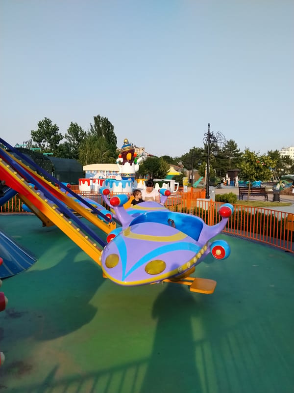 Colorful kiddie airplane ride at a Tiraspol amusement park