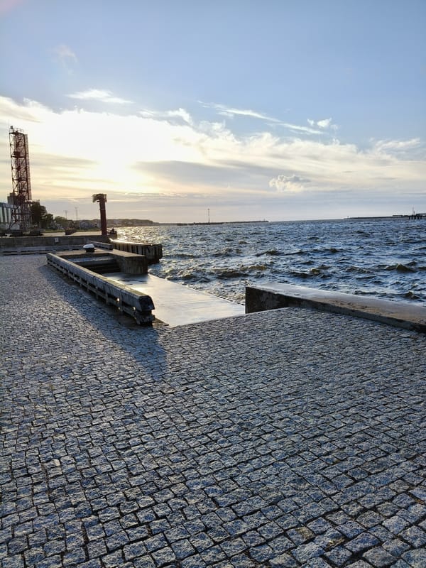 Ventspils waterfront at sunset, Baltic chop and industrial horizon