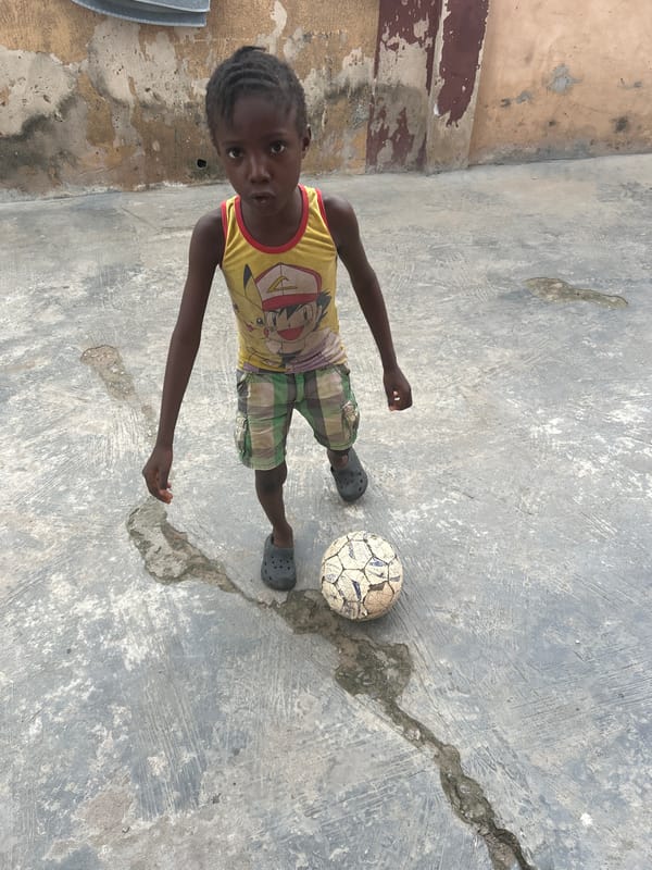 Children play and clean in Lagos courtyard