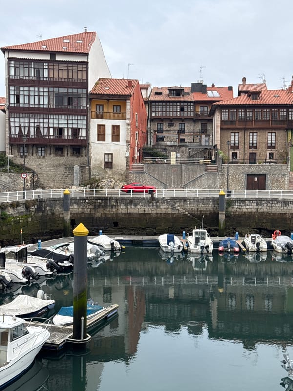 Morning walkthrough of Llanes harbor, breakwater, and old town streets