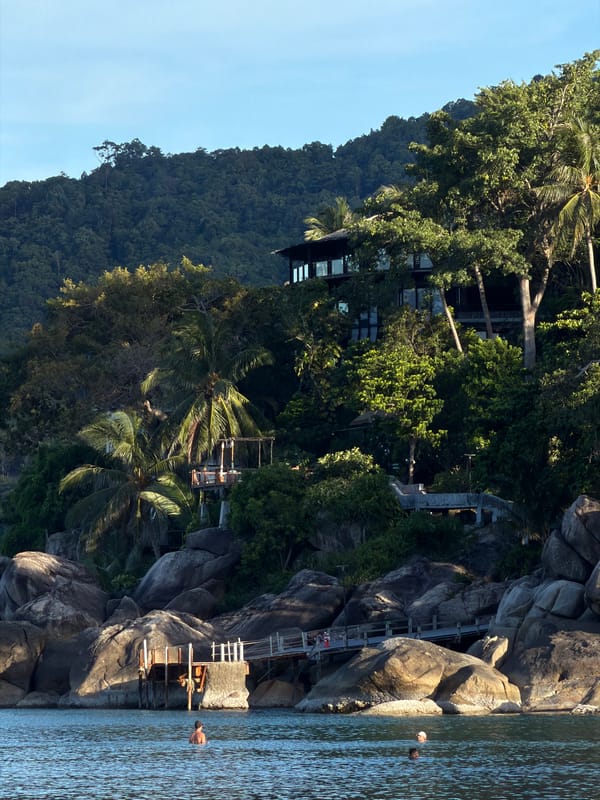 Hillside retreat and anchored sailboat along Ban Tai's coastline