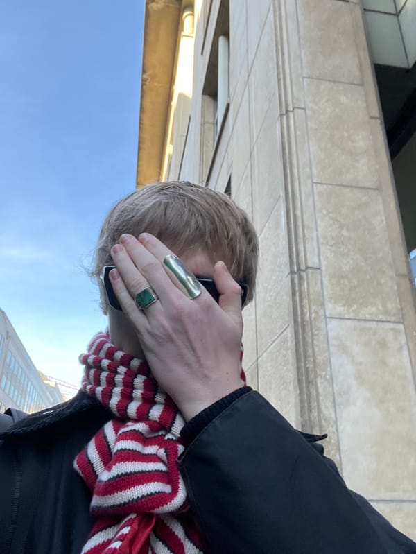 Person photographed with hand covering face in Brussels