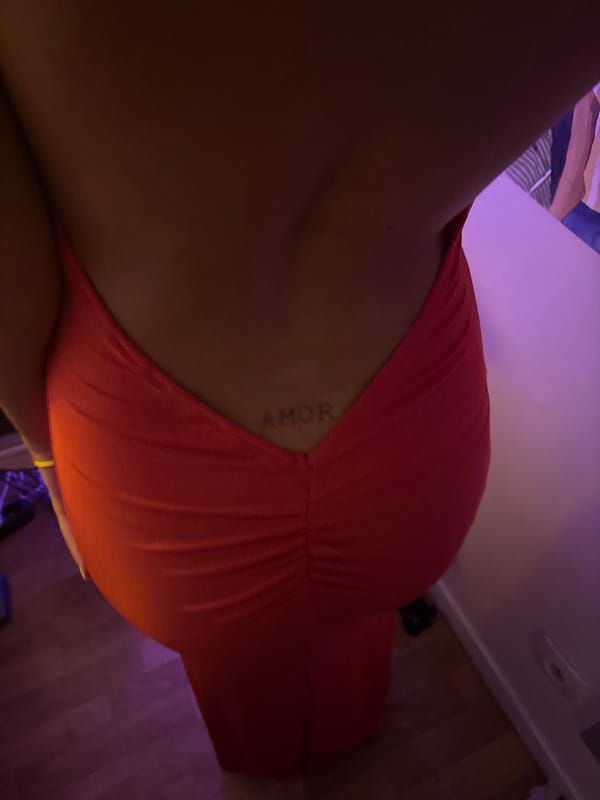 Person in orange dress photographed indoors in Paris