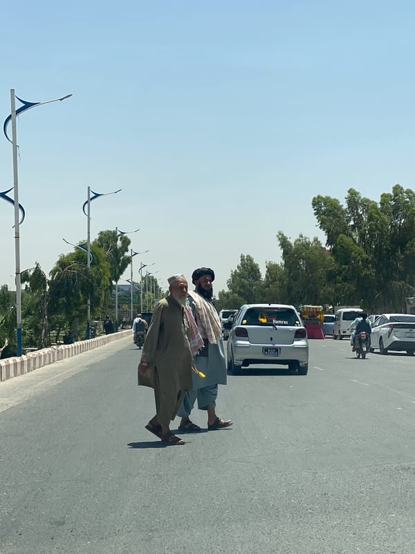 Two men cross street in Kandahar morning scene