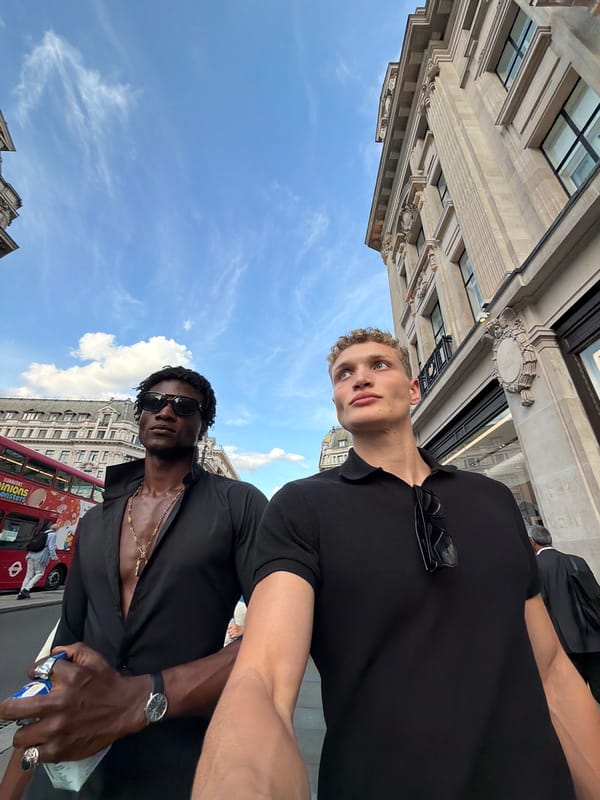 Pedestrians moving through a busy London street on a summer afternoon