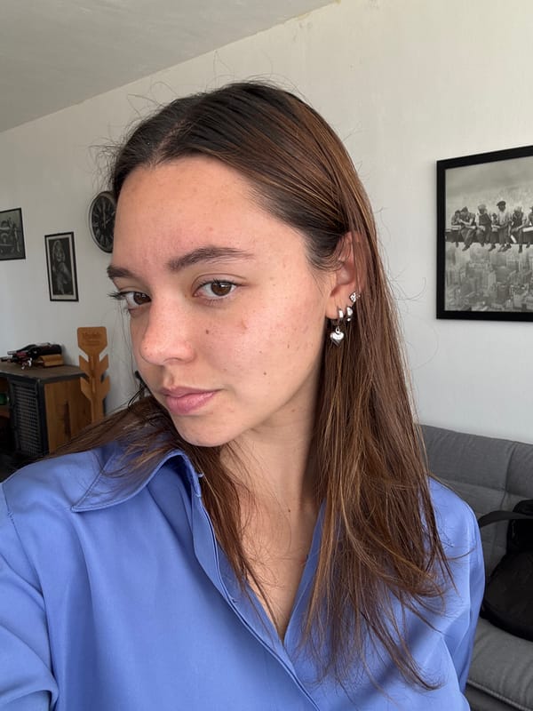Woman takes selfie near ornate wall in Mexican town