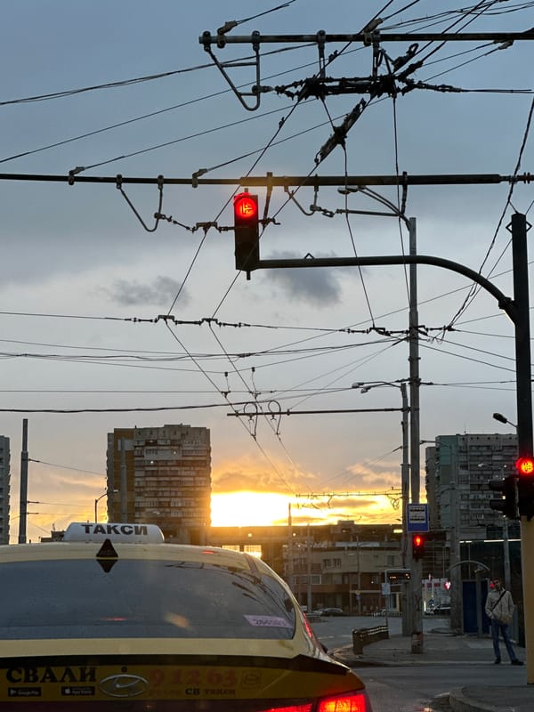 Sofia street scene captures tram wires at sunset