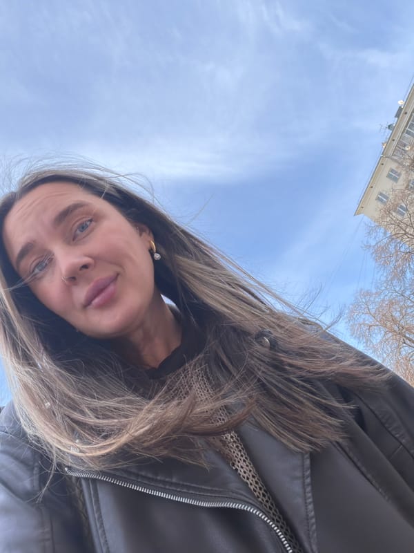 Woman films selfie video in windy Moscow courtyard