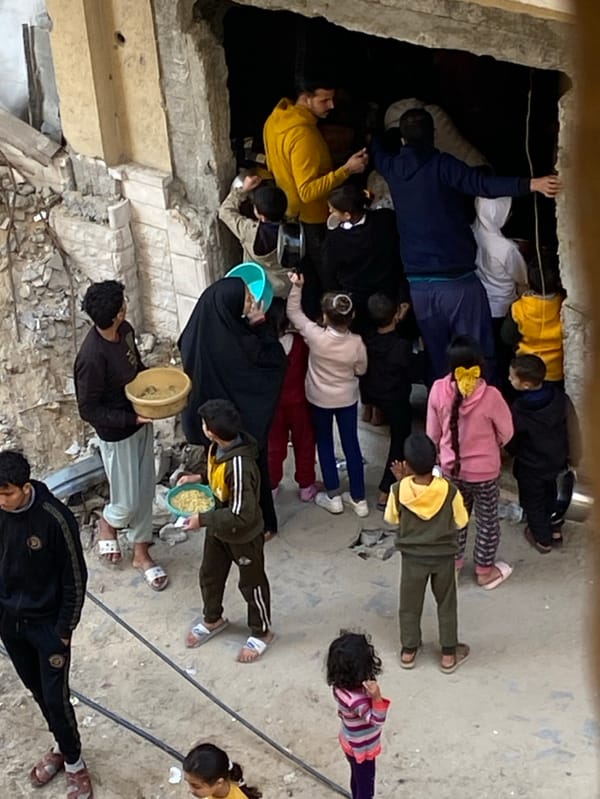 Crowds gather at damaged buildings in Khan Yunis