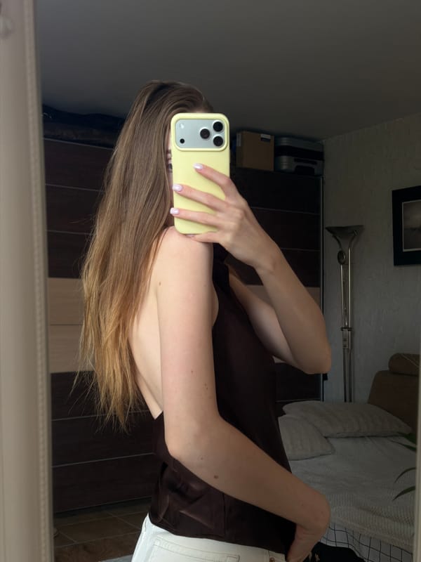 Woman Takes Multiple Mirror Selfies in Gorzow Bedroom