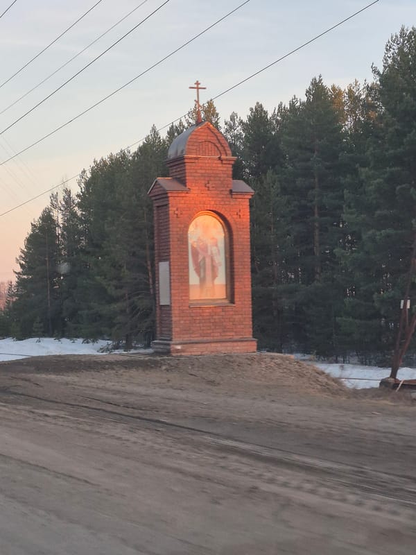 Brick wayside shrine documented in rural Noviy, Russia