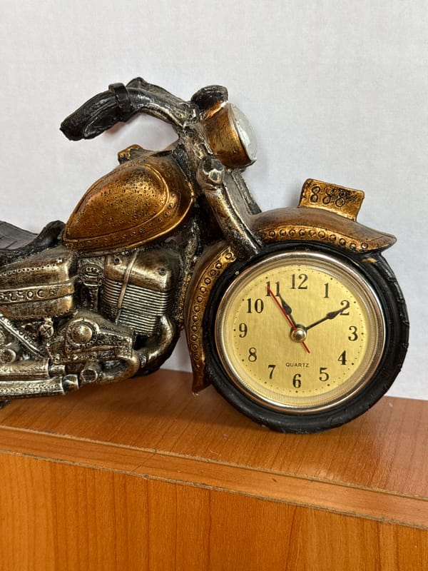 Decorative motorcycle clocks and ornate brass tea holders up close