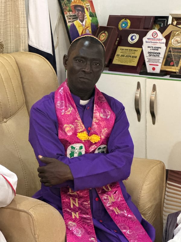 Clergy meeting in Narayi, Nigeria, with colorful vestments and prayer