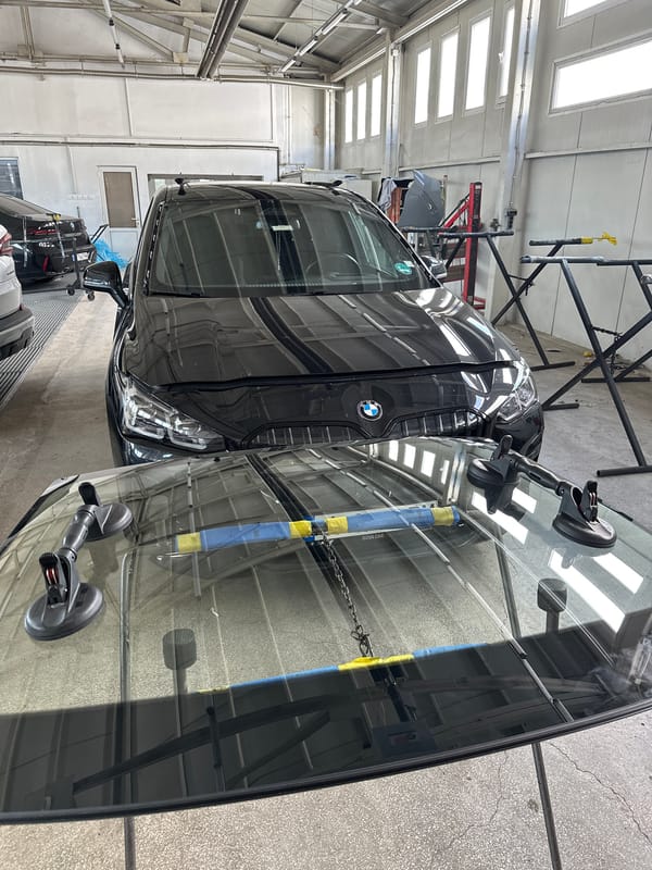 BMW receives windshield service at automotive workshop