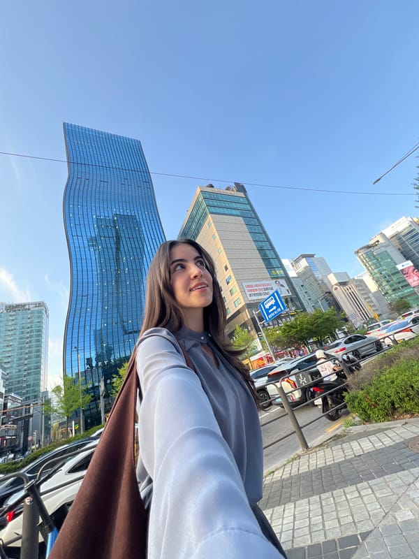 Woman takes selfie in Seoul wearing layered clothing