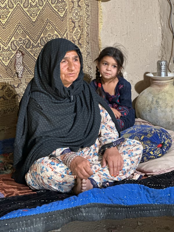 Elderly woman and young girl rest together in Quetta home