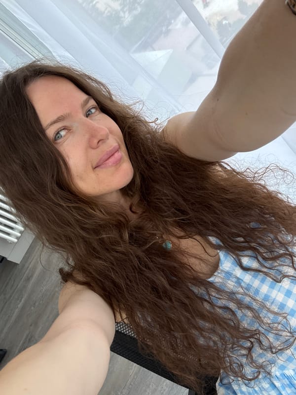 Morning selfie session in a Moscow home, blue gingham dress