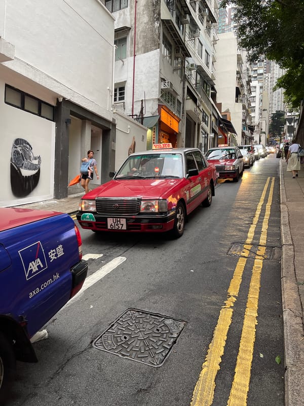 Hong Kong street scenes feature taxis, figurines, Hollywood mural