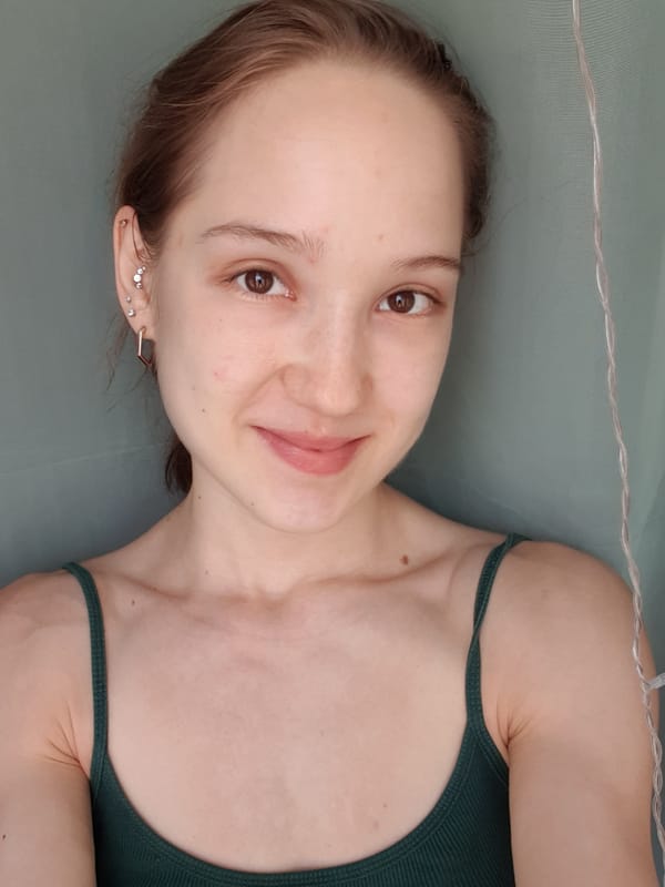 Woman takes selfie in dark green tank top in Khimki