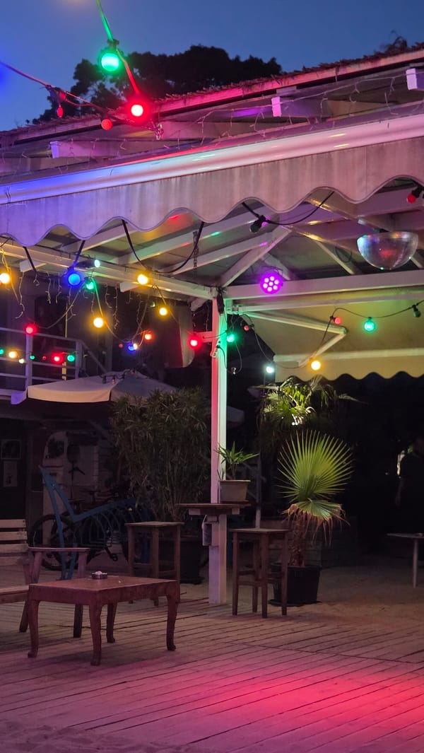 Evening waterside bar patio documented with festive lighting