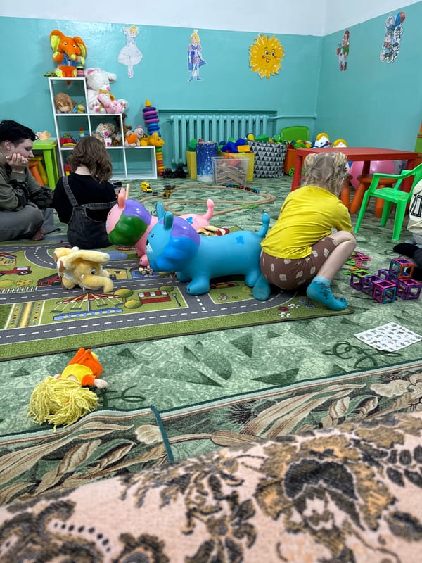 Child plays on toy animal in Anapa playroom