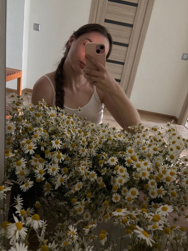Mirror selfies and daisy bouquet in a bedroom setting