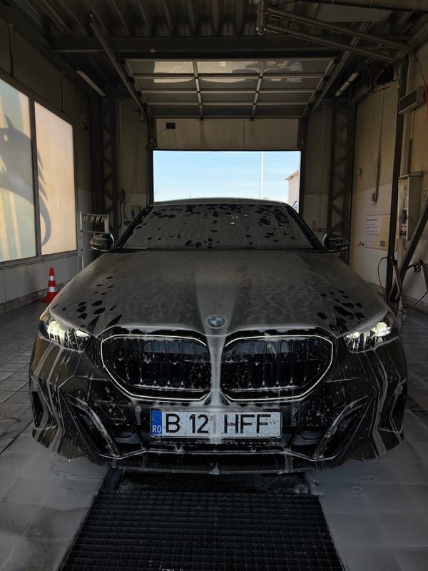Black BMW mid-wash at a Cluj-Napoca car wash
