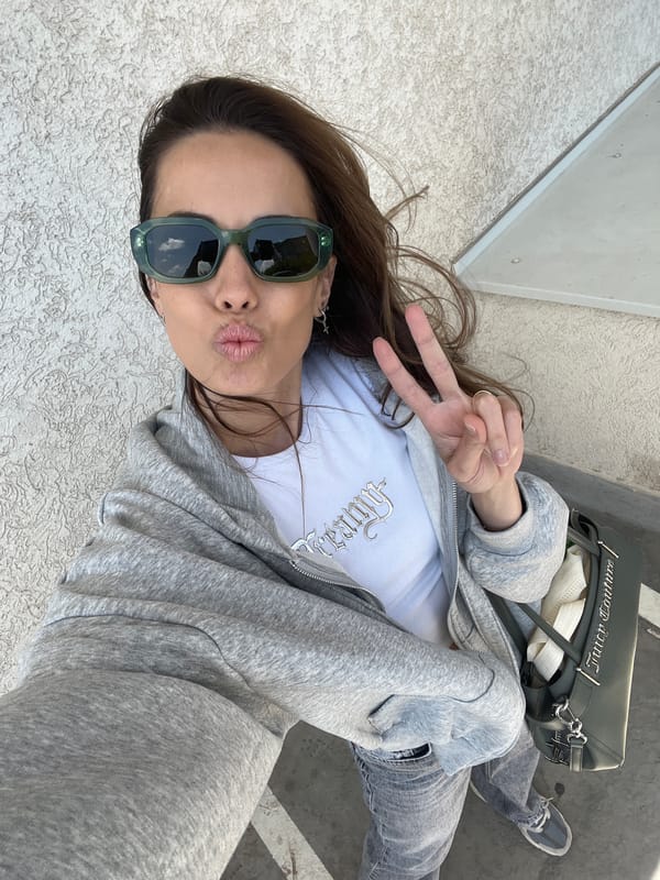 Woman takes selfie with peace sign in Bjeliši, Montenegro