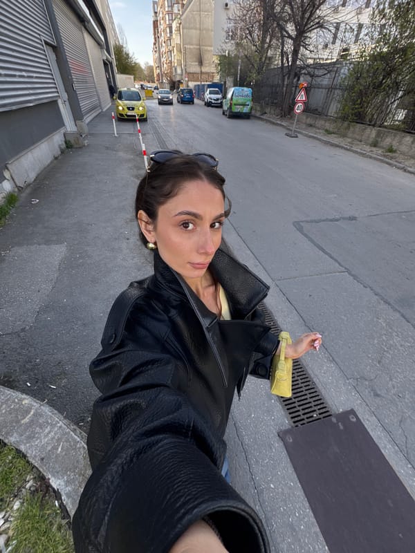 Woman Takes Multiple Selfies on Sunny Varna Street
