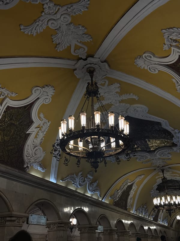 Tourist takes selfie at ornate Moscow metro station