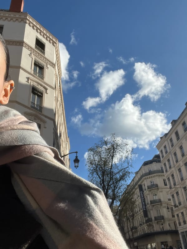 Low-angle street photography captures person against Lyon cityscape