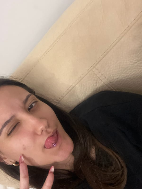 Woman poses playfully on couch in Varna apartment