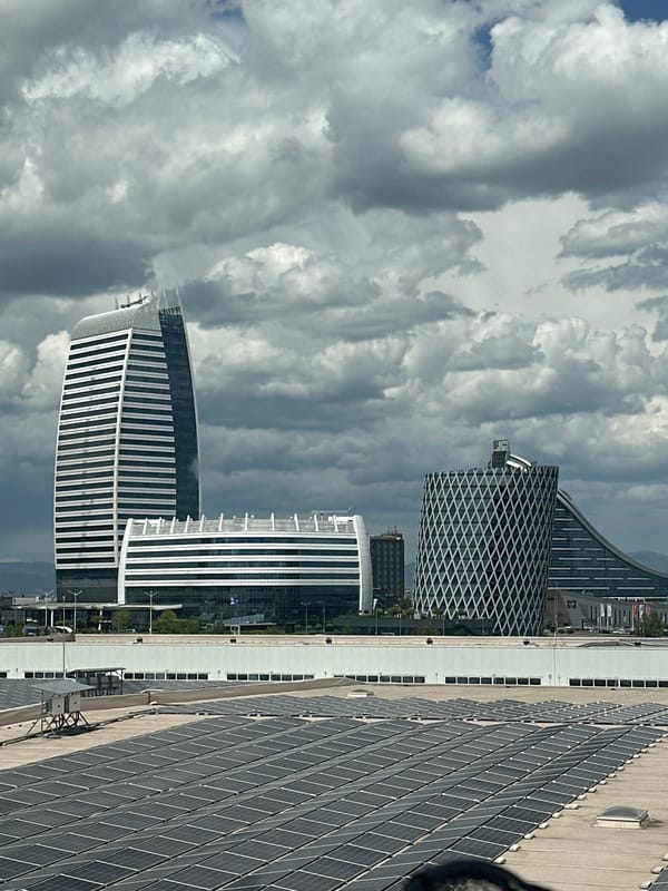 Solar-paneled building observed in Sofia cityscape under cloudy skies