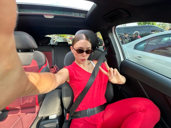 Woman makes peace sign while seated in car in Mexico
