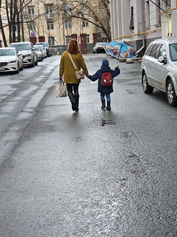 Pedestrians walk through wet streets in Khimki, Russia