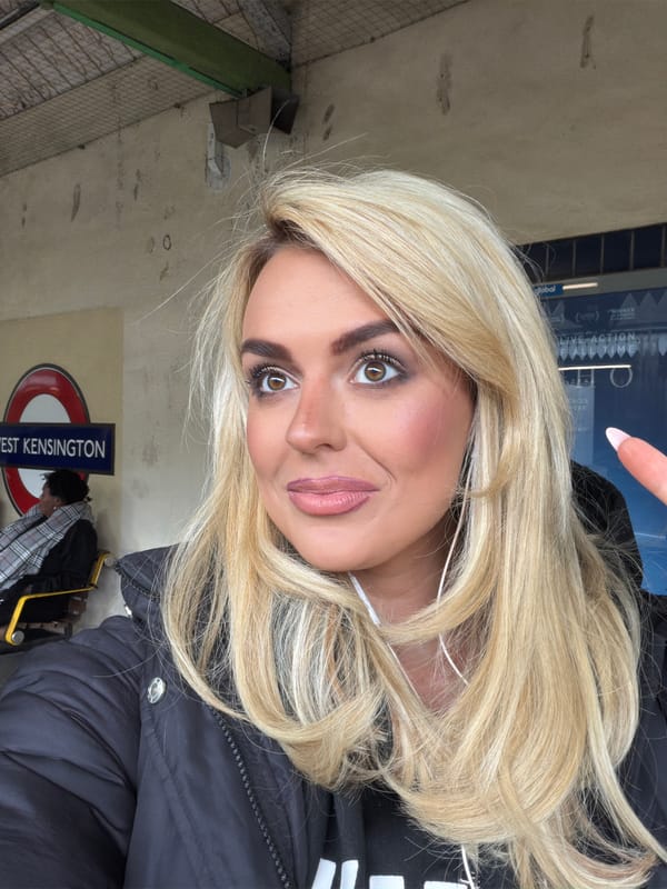 Woman takes selfie at West Kensington tube station