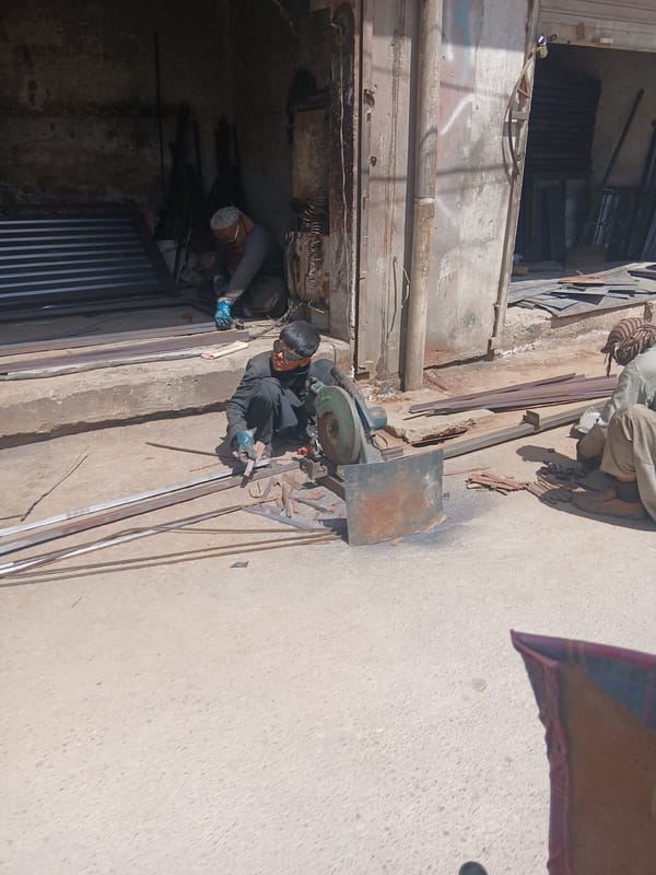 Morning scenes in Quetta: metalworker and children documented