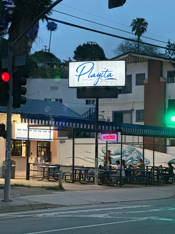 Late-night street scenes capture seafood restaurant and parking signage