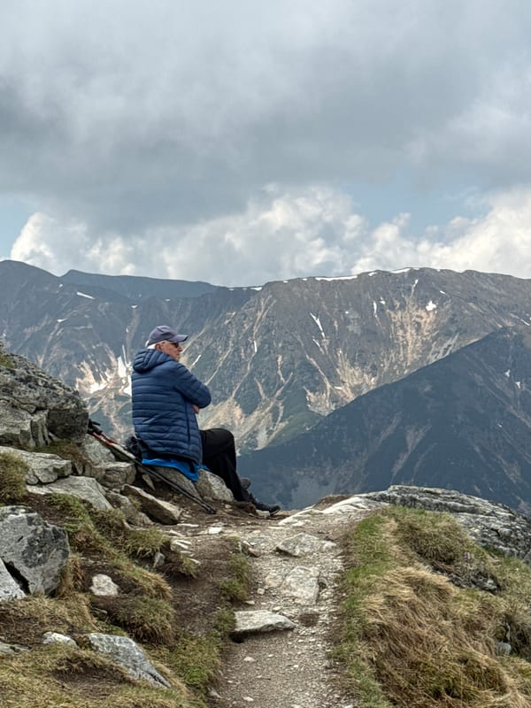 Hiker rests on cloudy Tatra Mountain trail near Zakopane
