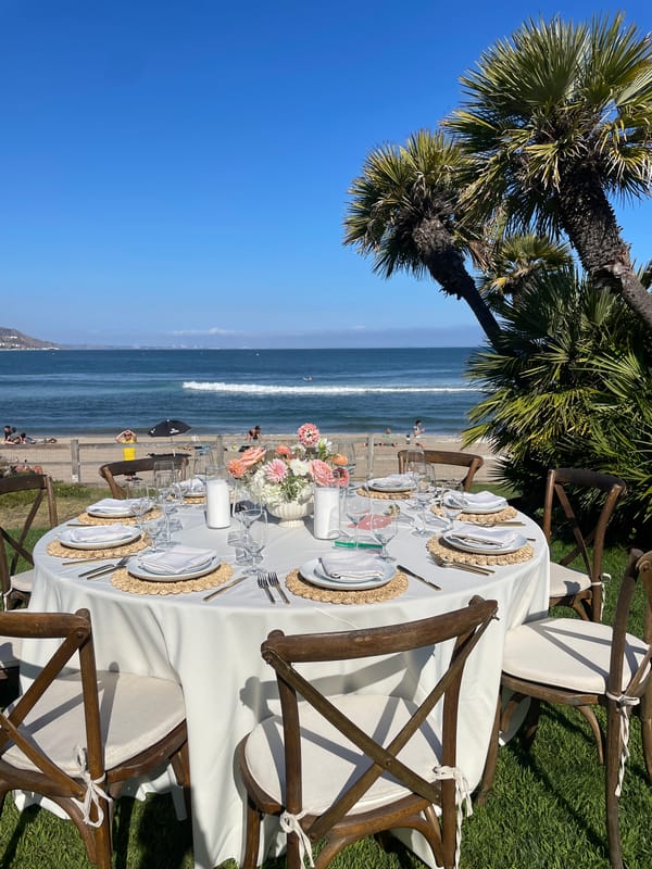 Elegant outdoor reception tables set overlooking the Malibu coast