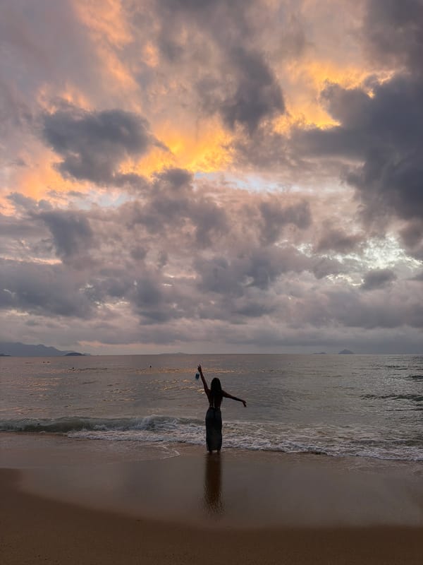 Beachgoer captured in surf at dusk in Nha Trang