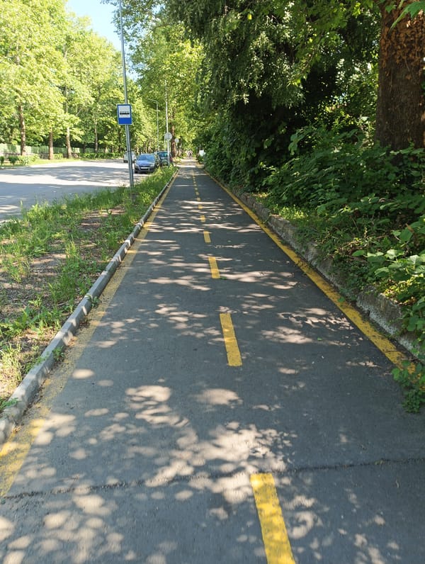 Urban infrastructure observed: marked pathway and metal storage tanks