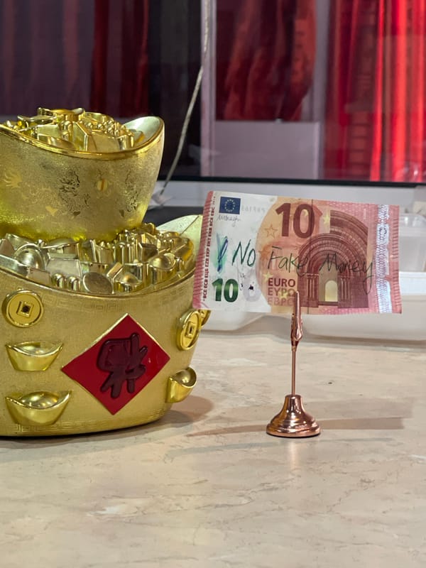 Gold Chinese figurine photographed with fake Euro note in Sofia