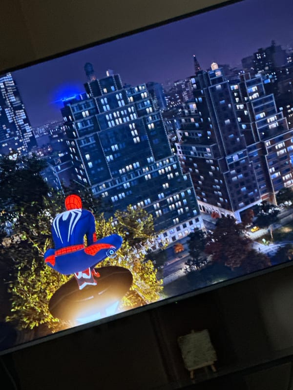Gamer plays Marvel's Spider-Man, swinging through virtual nighttime city